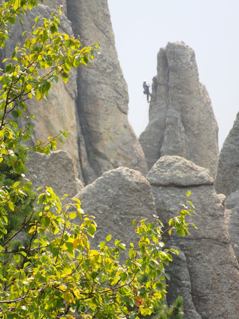 A rock climber ascending a spire