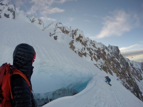 Danger looks on as two climbers work their way around a crevasse.